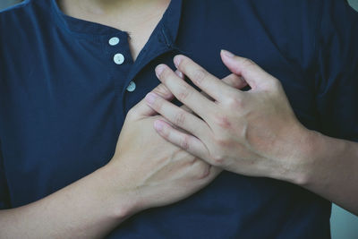 Midsection of couple holding hands