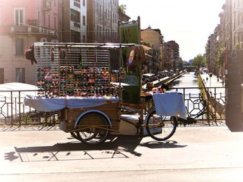 Bicycle on street against buildings in city