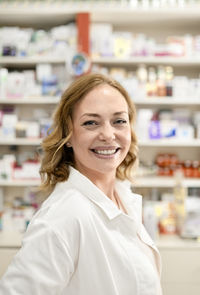 Happy female pharmacist at pharmacy store