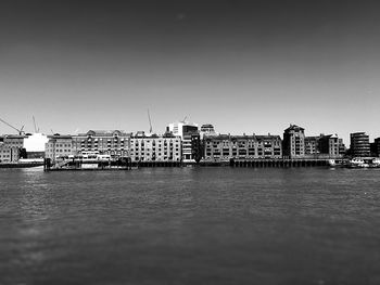 View of city by sea against clear sky