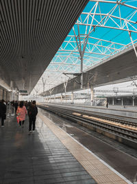 People walking on railroad station platform