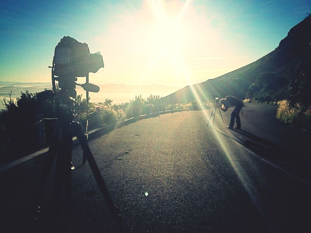 transportation, sunlight, sun, lifestyles, men, sky, the way forward, mode of transport, land vehicle, leisure activity, road, sunbeam, person, walking, bicycle, car, street, rear view