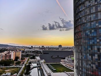 Buildings in city during sunset