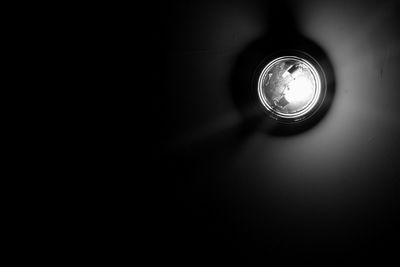 Close-up of electric lamp in darkroom
