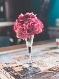 Close-up of pink rose on table