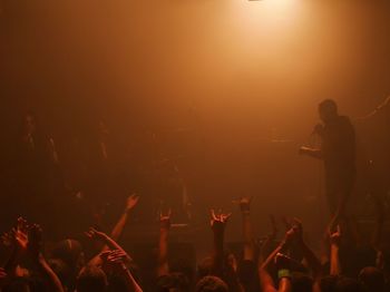 Singer performing in front of fan in concert