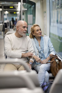 Senior couple sitting in a tram