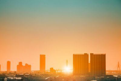 Cityscape against clear sky during sunset