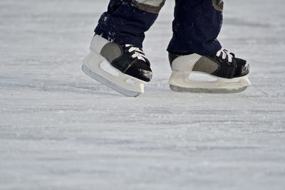 Low section of person ice-skating on rink