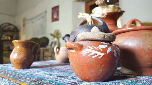 Close-up of earthen pots on table