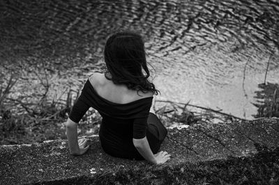 Rear view of woman sitting outdoors