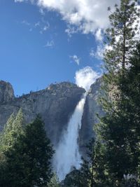 Low angle view of waterfall against sky