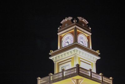 Low angle view of illuminated building against sky at night