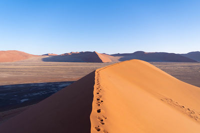 Scenic view of desert against clear sky