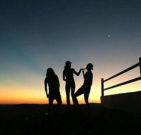 SILHOUETTE OF PEOPLE AT SUNSET