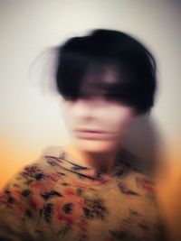 Portrait of woman against wall