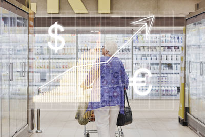 Financial chart and senior woman shopping in supermarket