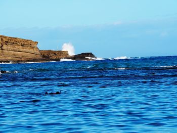 Scenic view of sea against blue sky