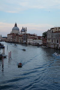 Boats on grand canal against sky during sunset