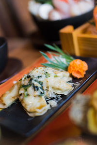 Close-up of food in plate on table by appetizer menu