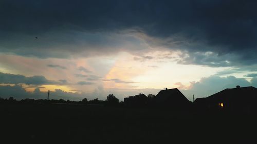 Silhouette trees against sky during sunset