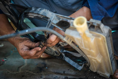 Midsection of man working in workshop