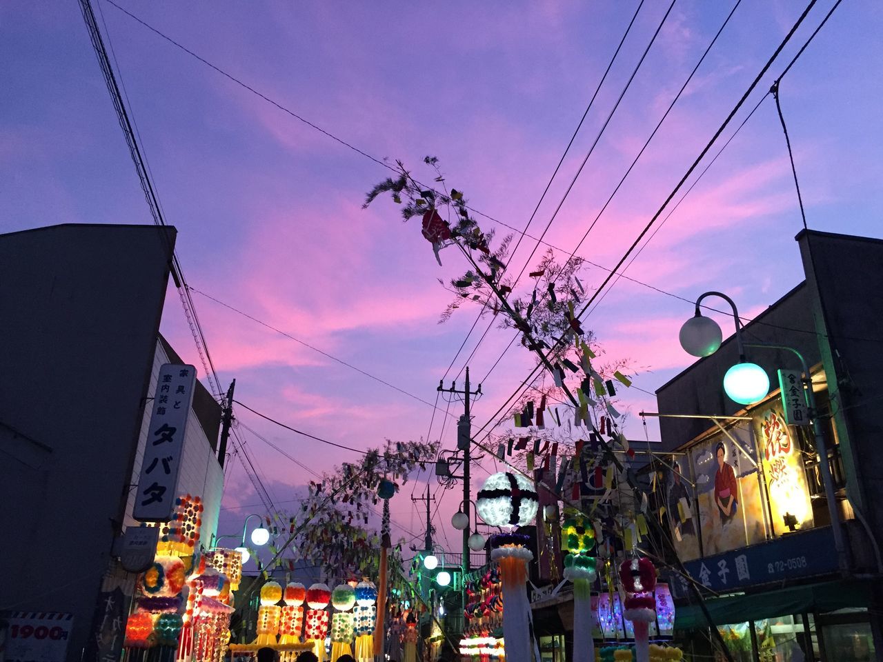 building exterior, architecture, built structure, sky, city, low angle view, residential building, residential structure, power line, house, residential district, cable, cloud - sky, building, illuminated, dusk, city life, cityscape, outdoors, electricity