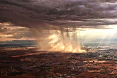 Aerial view of landscape against cloudy sky