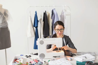 Portrait of young woman wearing eyeglasses on table