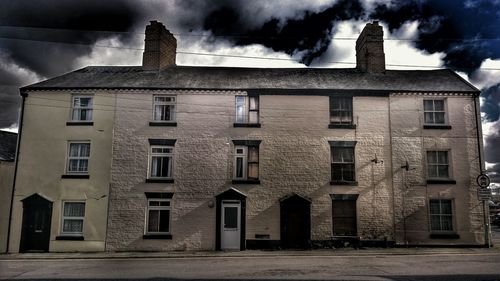 Buildings against cloudy sky