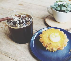 Close-up of iced coffee and dessert on table