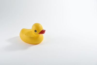 Close-up of yellow toy over white background