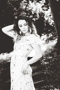 Woman standing by tree