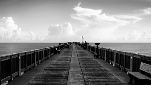 Pier in sea against sky