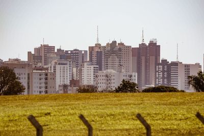 View of buildings in city against clear sky