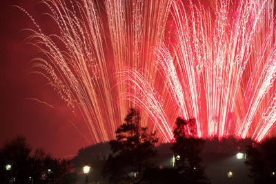 Low angle view of firework display at night