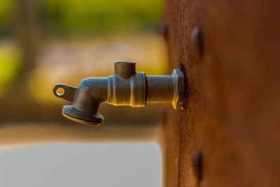 Close-up of faucet against blurred background