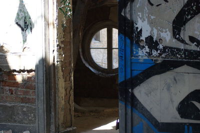 Panoramic shot of abandoned building seen through window
