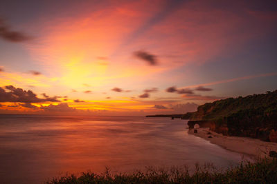 Scenic view of sea against romantic sky at sunset
