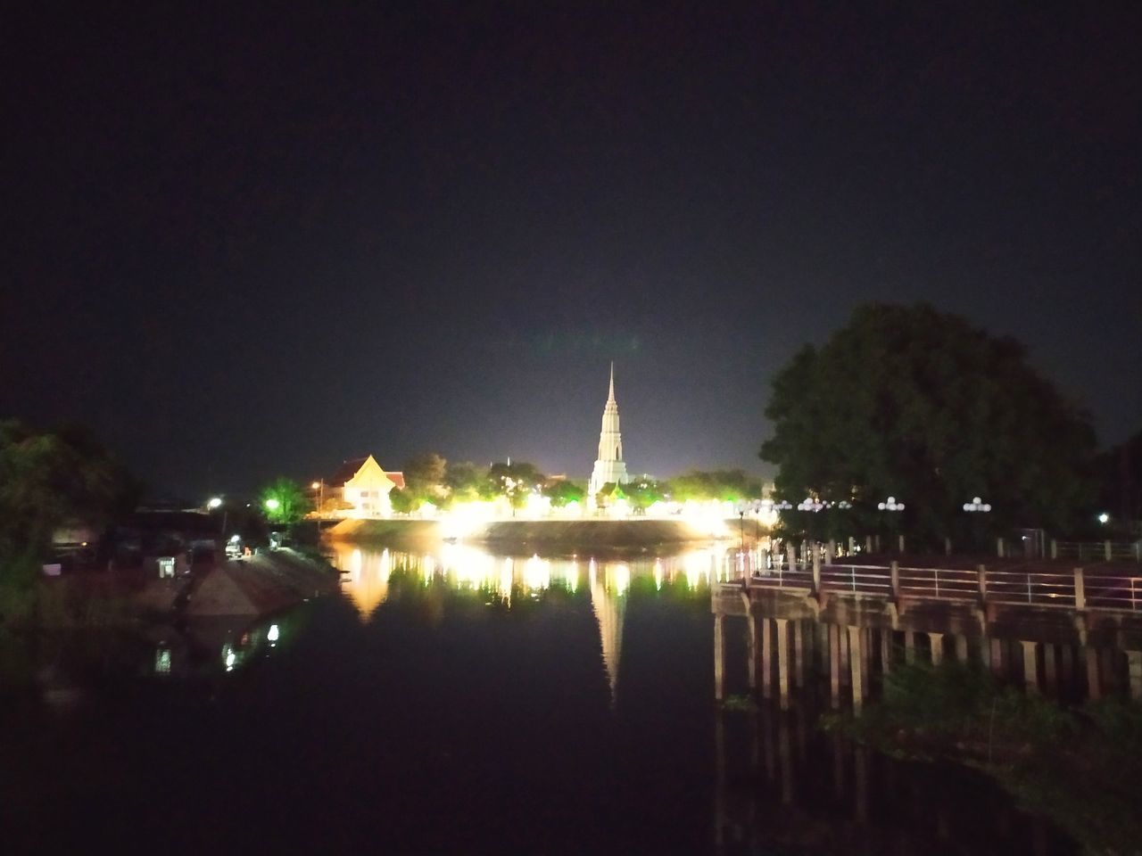 REFLECTION OF ILLUMINATED BUILDINGS IN WATER AT NIGHT