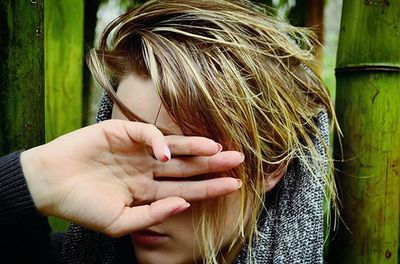 Close-up of hand holding cigarette