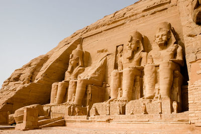 Huge statues of egyptian king ramses ii seated at the entrance to the great temple at abu simbel