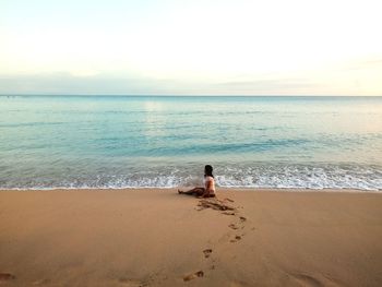 Man looking at sea against sky