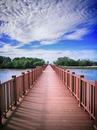 Pier over lake against sky