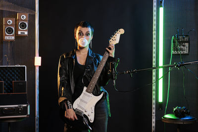 Portrait of young man playing guitar