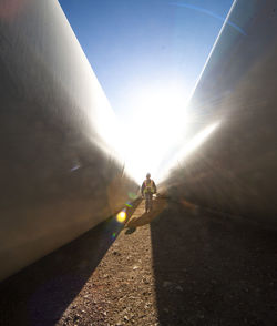 Person walks between blades at wind farm in ft. davis, texas