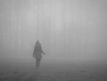 Man standing in foggy weather