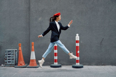 Low angle view of woman standing against wall