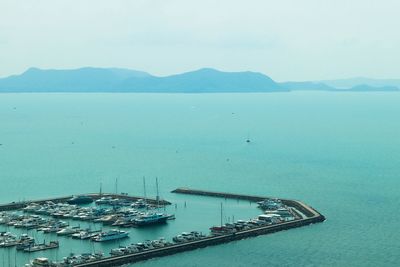 High angle view of boats in sea against sky