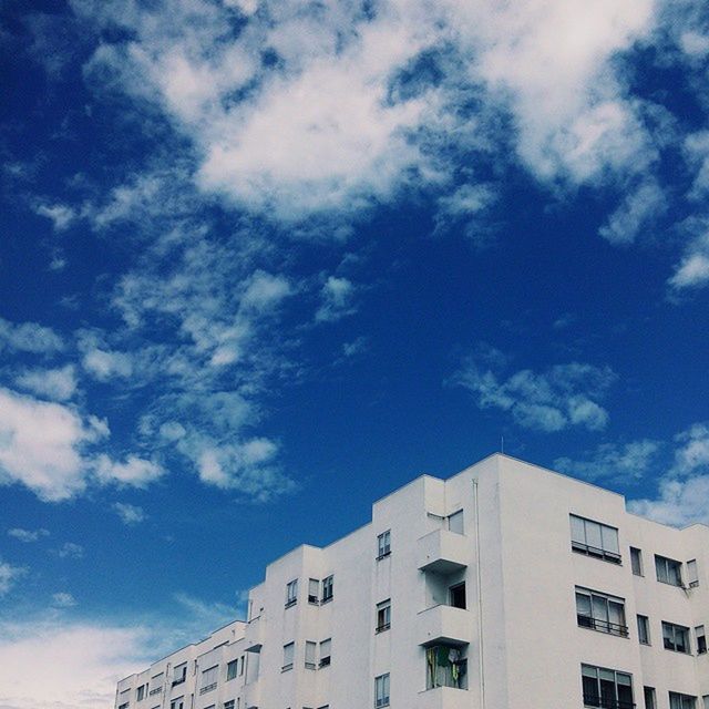 building exterior, architecture, built structure, low angle view, sky, residential building, residential structure, building, blue, cloud - sky, window, city, cloud, house, high section, day, outdoors, no people, cloudy, sunlight